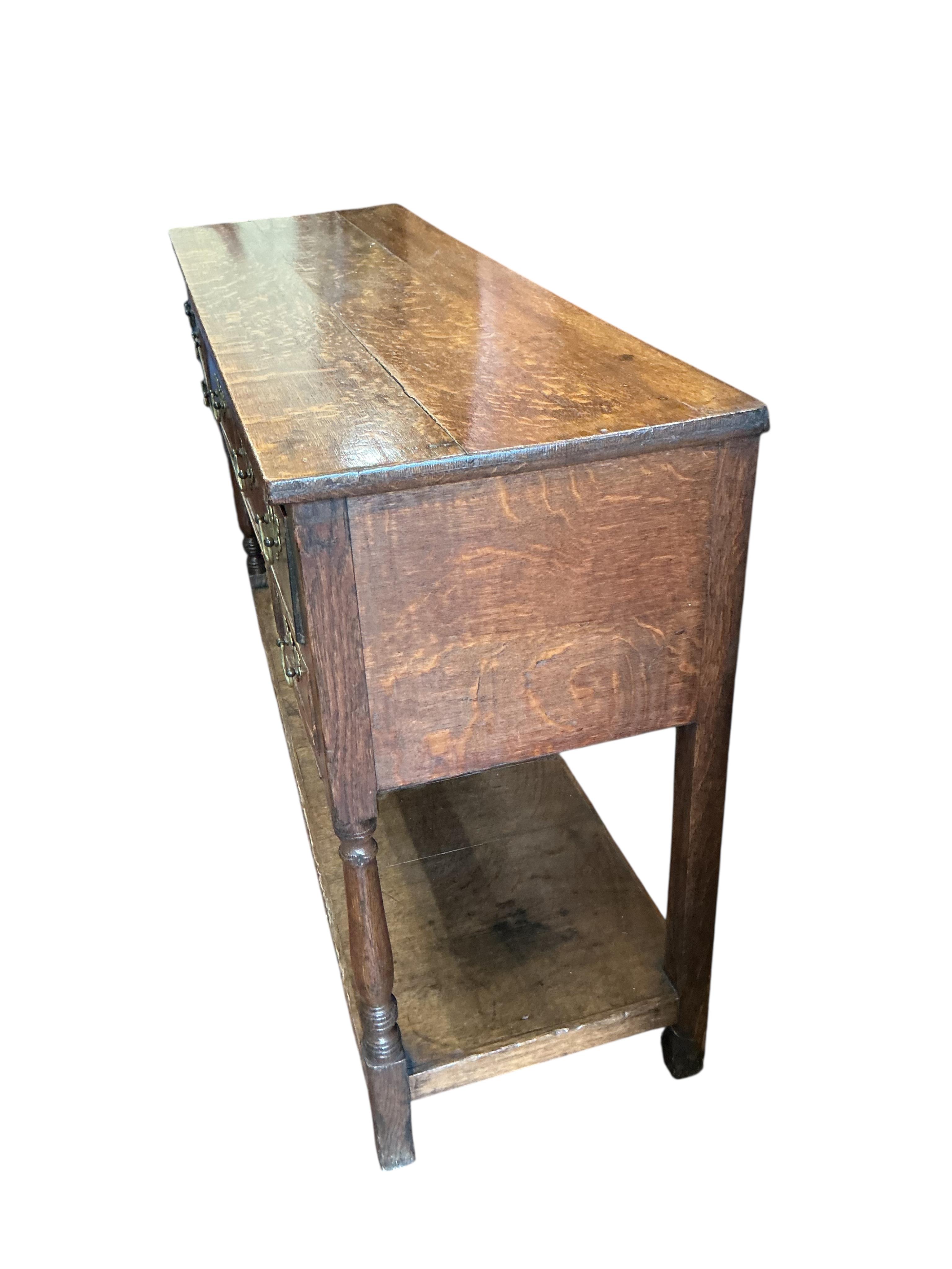 A small George III oak low pot board dresser, width 125cm, depth 39cm, height 79cm